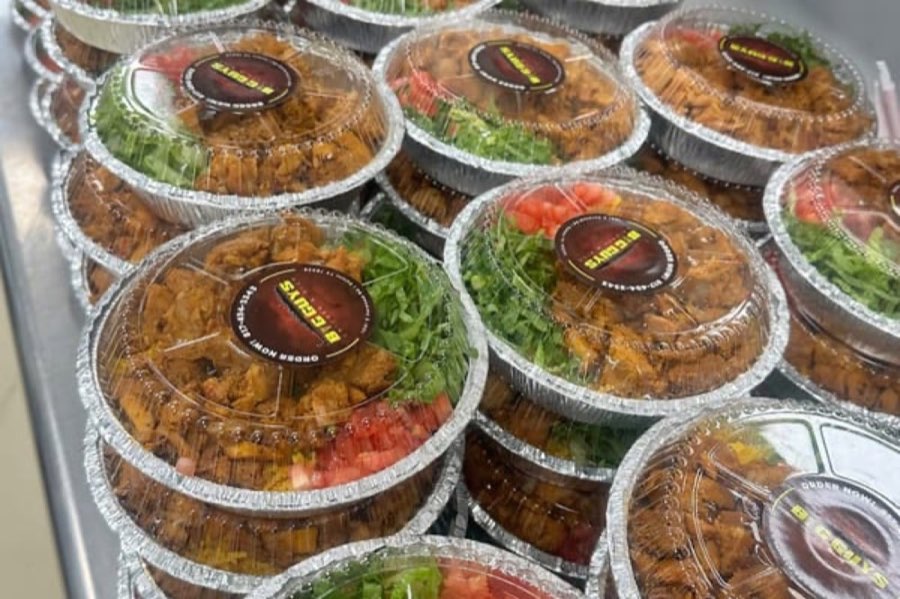 Branded Big Guy’s takeout trays containing seasoned chicken and salad