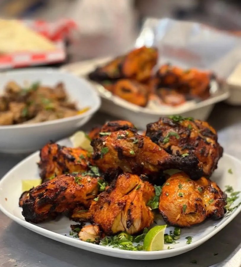 Grilled chicken with lime wedges from Cafe De Khan’s official gallery