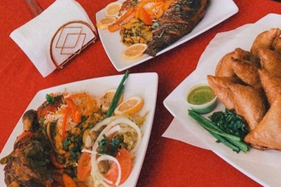 Fish, chicken with rice, and sambusas at Cafe Madina.