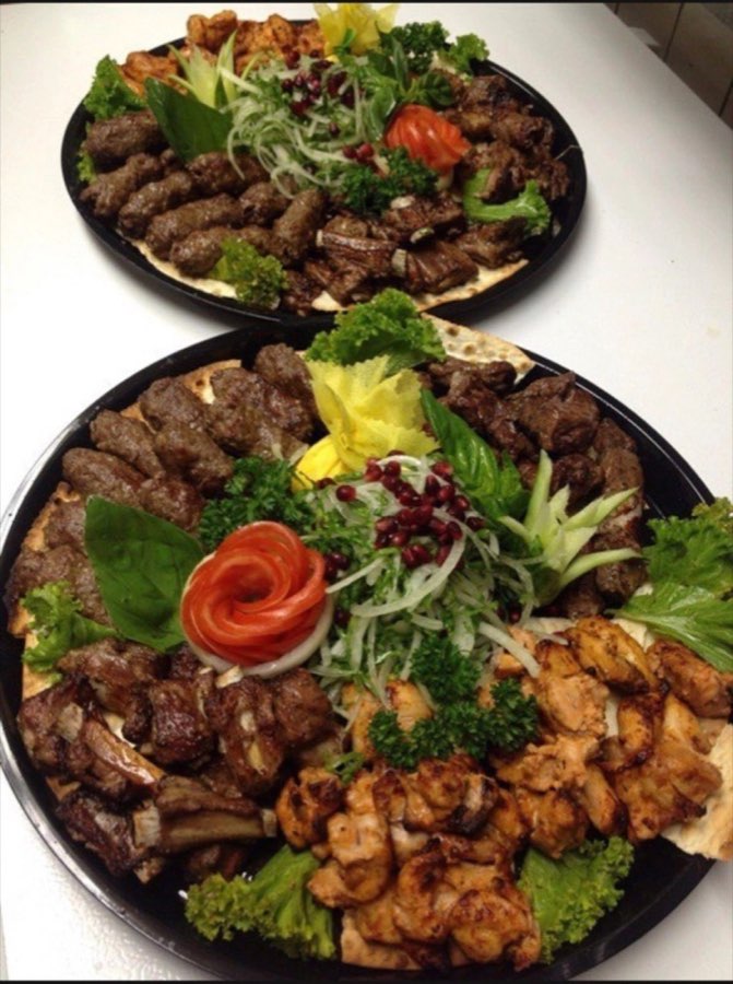 Mixed grill platters with chicken, kebabs, vegetables and herbs