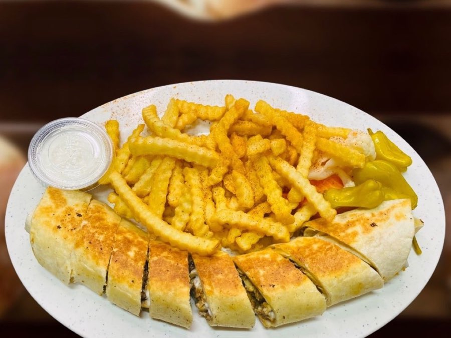 Shawarma Basha's chicken platter with a sliced toasted wrap, crinkle fries, peppers and sauce