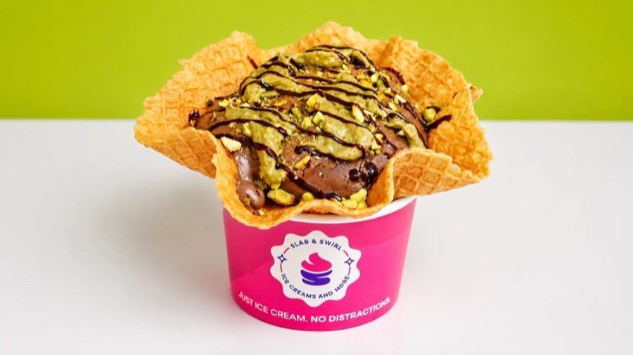 Dubai Chocolate Ice Cream with pistachio topping in a waffle bowl and pink Slab & Swirl cup