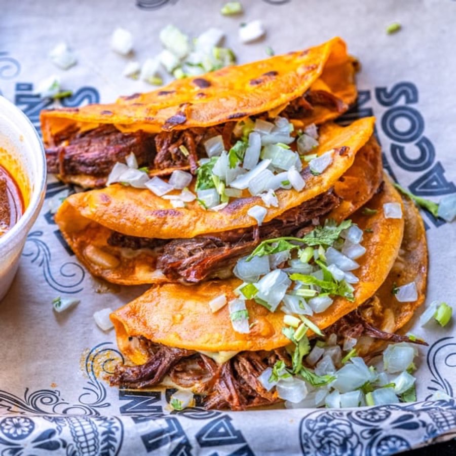 Birria tacos with onions and cilantro from Talkin’ Tacos.