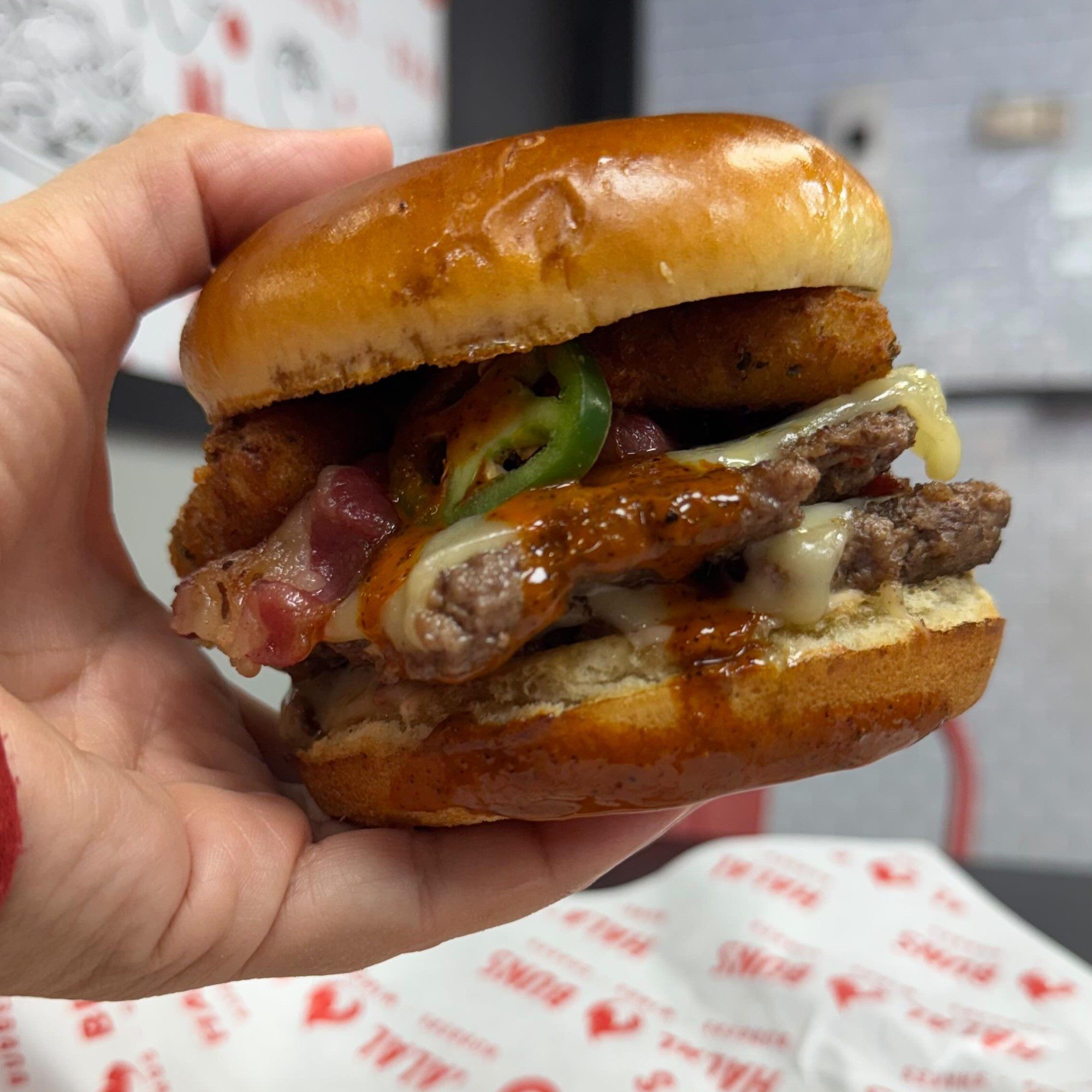 Halal Buns burger with melted cheese and fresh toppings