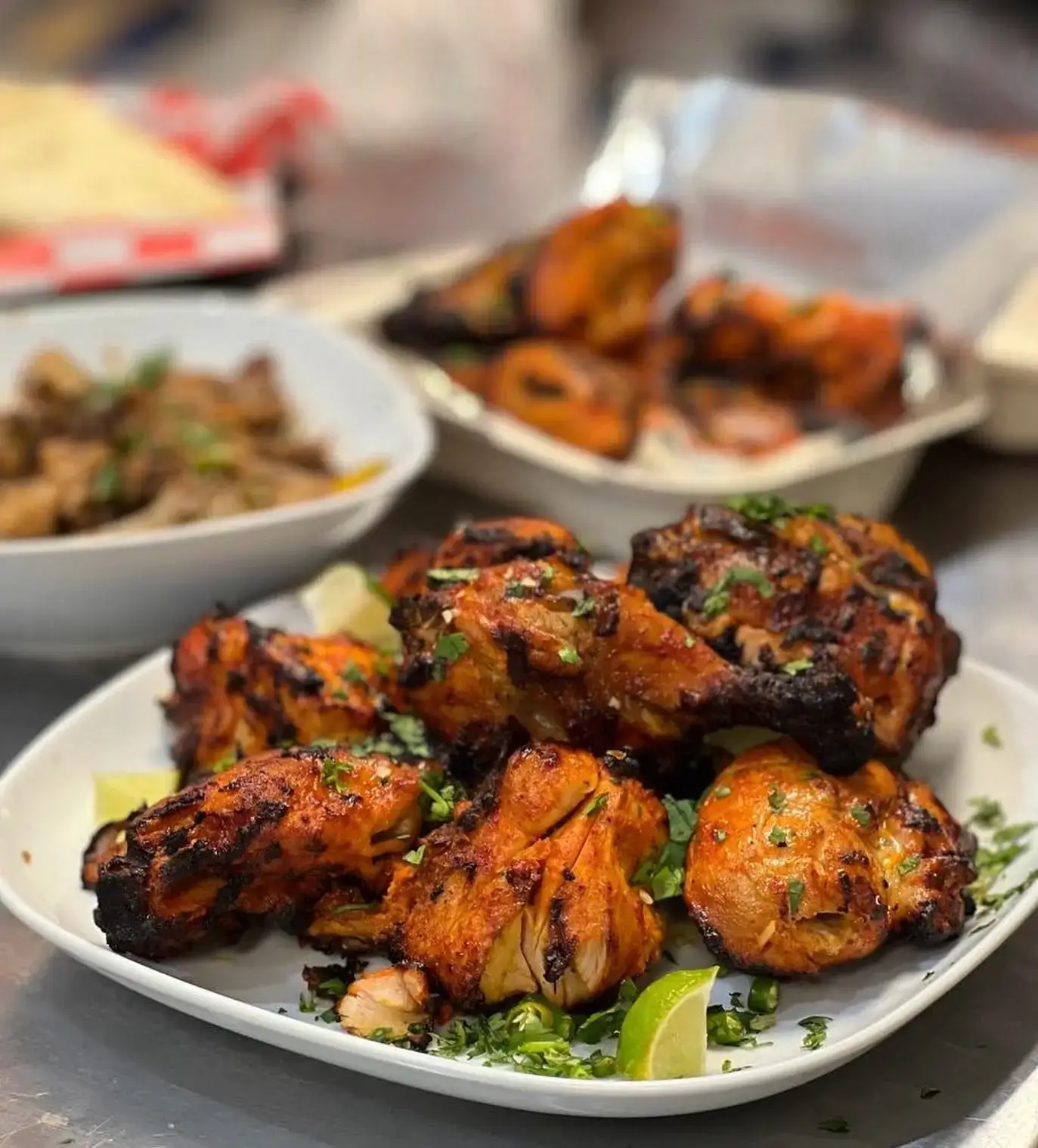 Grilled chicken with lime wedges from Cafe De Khan’s official gallery