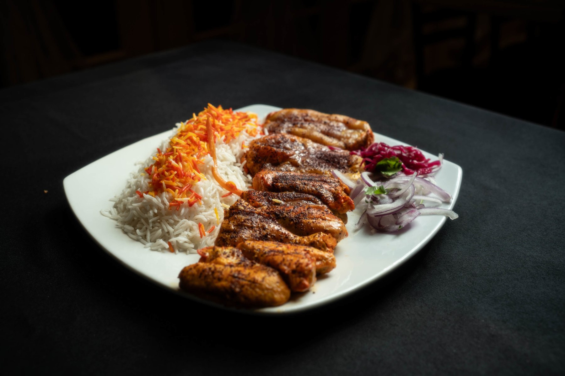 Grilled chicken with long-grain rice, onion and pickled cabbage